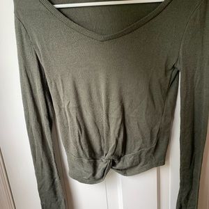 a long sleeve shirt with a knot at the bottom
